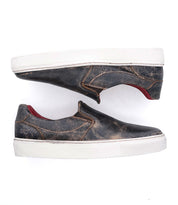 A pair of black slip on Hermione sneakers with red soles from Bed Stu.