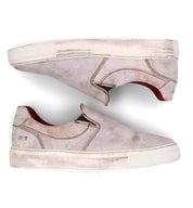 A pair of Hermione sneakers by Bed Stu with red soles.