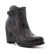Isla Black leather heeled bootie with vintage buckle accent by Bed Stu on white background.