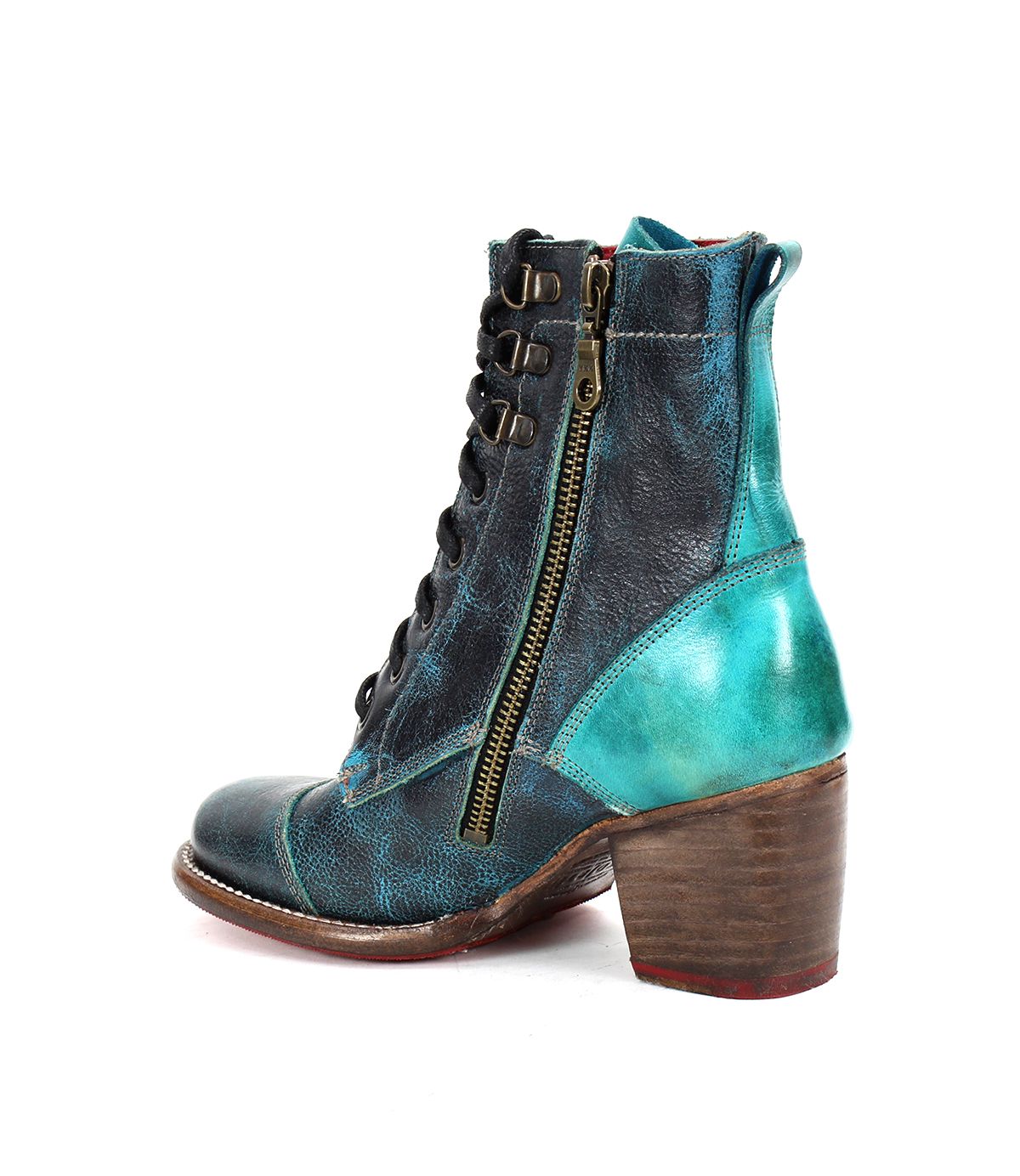 The Judgement by Bed Stu is a high-heeled leather boot featuring blue and turquoise tones, a lace-up front, side zipper, and a comfortable block heel. This iconic design effortlessly combines style and practicality.