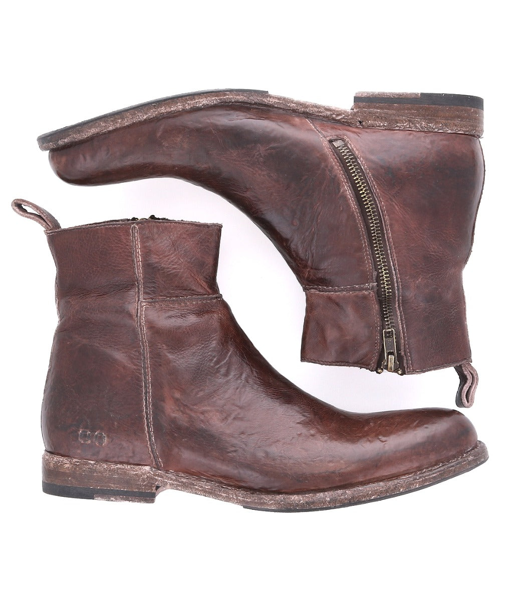A pair of worn Bed Stu Kaldi brown leather ankle boots with side zippers, designed for comfort, displayed against a white background.