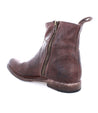 A worn brown leather Kaldi ankle boot with a zipper on the side, viewed from a slight angle against a white background. (Brand: Bed Stu)