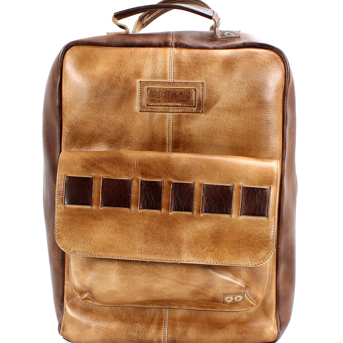 A handcrafted brown leather backpack with a top handle, front flap pocket, and dark brown accents made from vegetable-tanned leather, Kamet by Bed Stu.