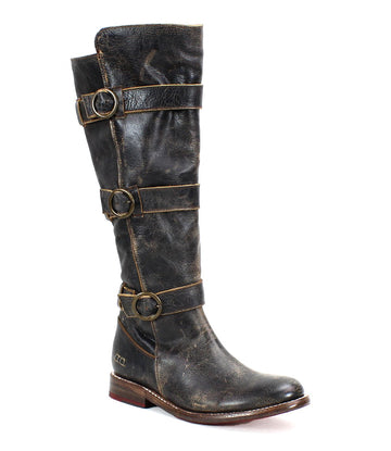A tall beauty, the Bed Stu Kitty single worn black leather knee-high boot showcases a distressed finish with edgy sophistication, featuring three adjustable buckles for a customizable fit along the shaft and a low wooden heel.