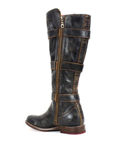 A single tall Kitty leather boot by Bed Stu, featuring adjustable straps, a side zipper, and a worn vintage look.