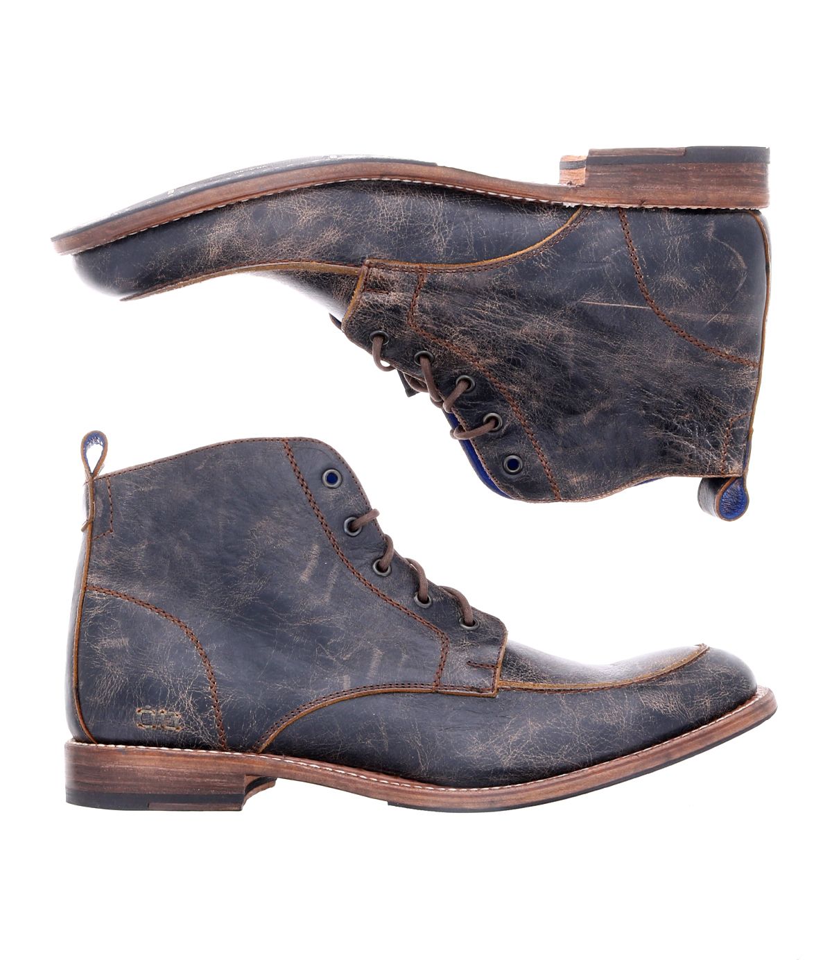 The Lincoln II boots by Bed Stu, crafted from brown leather with a distressed finish, are displayed side by side. One stands upright while the other, showcasing its 5-eye lace-up design, lies on its side to emphasize the intricate design and sole details. These versatile Lincoln II boots seamlessly transition from rugged workwear to a polished look.