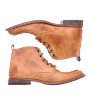 A pair of Lincoln II boots by Bed Stu, crafted from classic brown leather and viewed from the side. These lace-up boots feature slightly worn soles and visible stitching details, providing a versatile dressed-up appearance while maintaining a hint of rugged work boot durability.