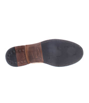 The image showcases the sole of the Lincoln II, a classic lace-up dress shoe by Bed Stu, featuring a combination of leather and rubber, detailed stitching, and the brand's logo.