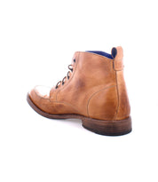 The Lincoln II by Bed Stu is a tan leather ankle boot featuring dark brown laces and a wooden sole, seen from the back angle, capturing the essence of a classic lace-up style for an elegant appearance.