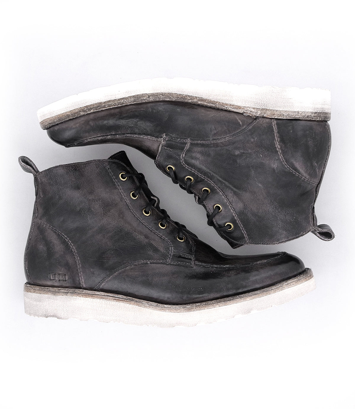 A pair of worn men's Lincoln leather work boots by Bed Stu with laces on a white background.