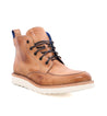 A single Bed Stu men's tan leather work boot with dark laces, featuring a blue accent on the pull tab and a white sole, isolated on a white background.