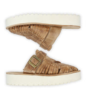 The Bed Stu Linette sandals feature hand-woven leather and a thick white platform sole with a secure buckle closure. They incorporate an XL EXTRALIGHT® outsole for comfort and modern style, viewed from the side.