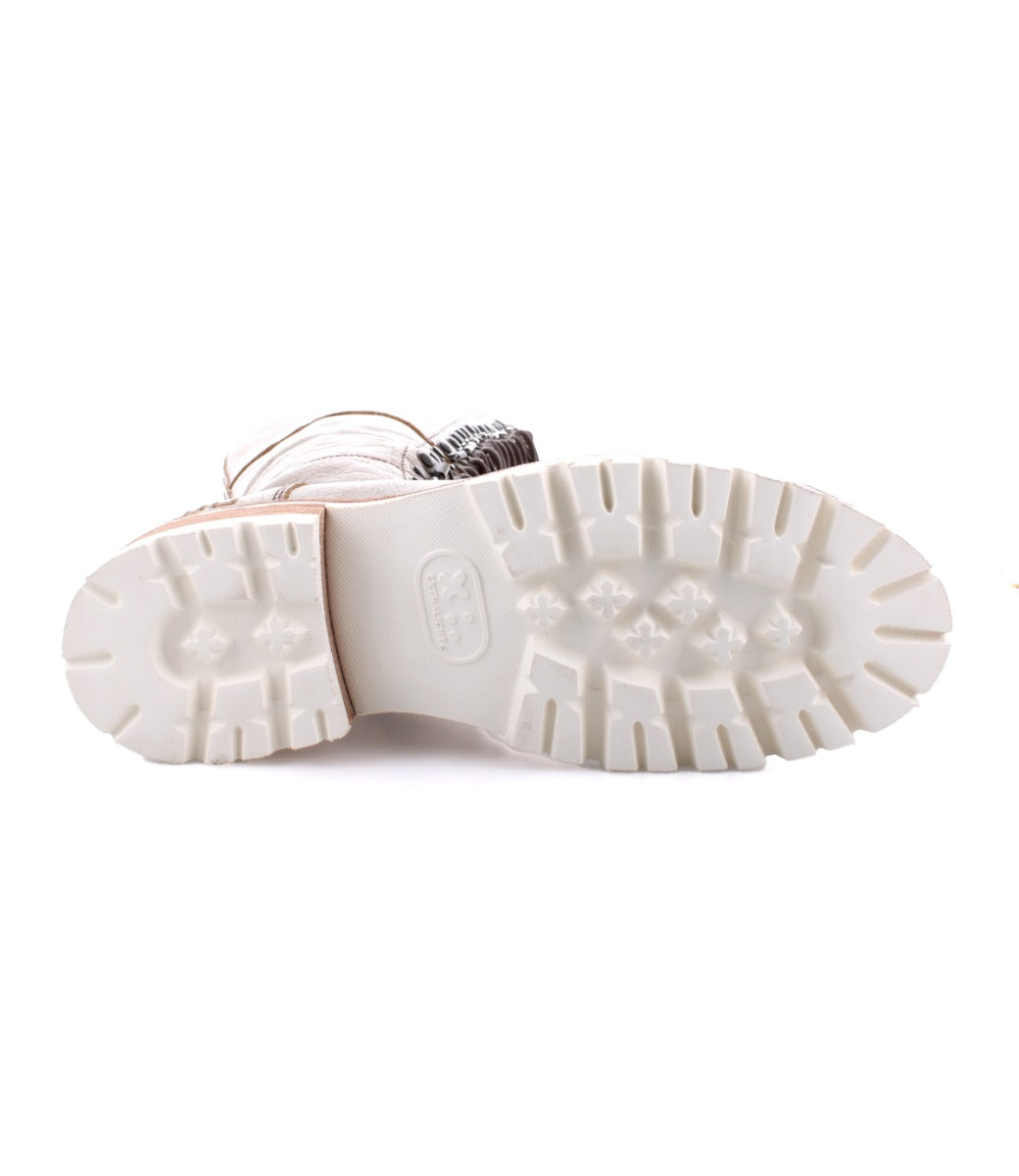 A women's Lustrous shoe with a white sole and a silver buckle, by Bed Stu.