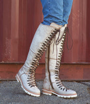 A woman wearing a pair of Lustrous jeans and a pair of Bed Stu boots.