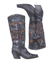 A pair of Bed Stu's Meadow black cowgirl boots featuring brown flame-shaped details, floral inlay designs, and side zippers, viewed from both the left side and the bottom sole.