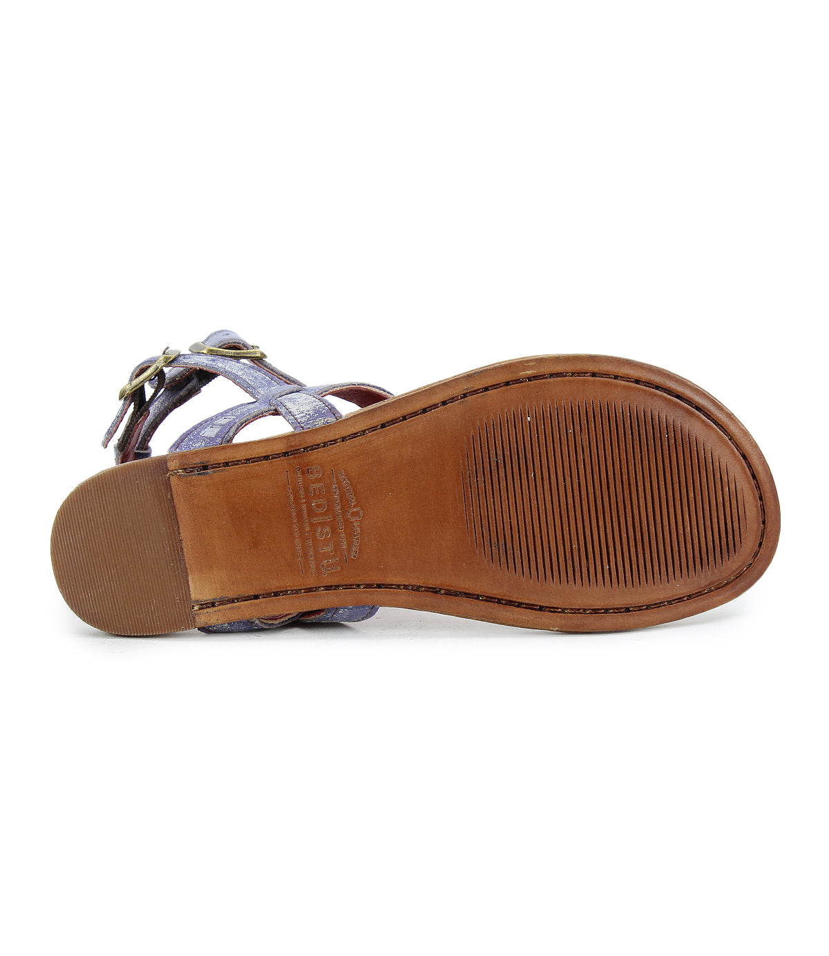 Bottom view of the Moon sandal reveals a light brown sole with textured grip, labeled "Bed Stu," showcasing artisanal craftsmanship.