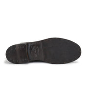 A pair of Bed Stu Nando brown leather ankle boots with studs on the sole.