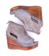 A pair of Odette women's wedge sandals with a wooden platform from Bed Stu.