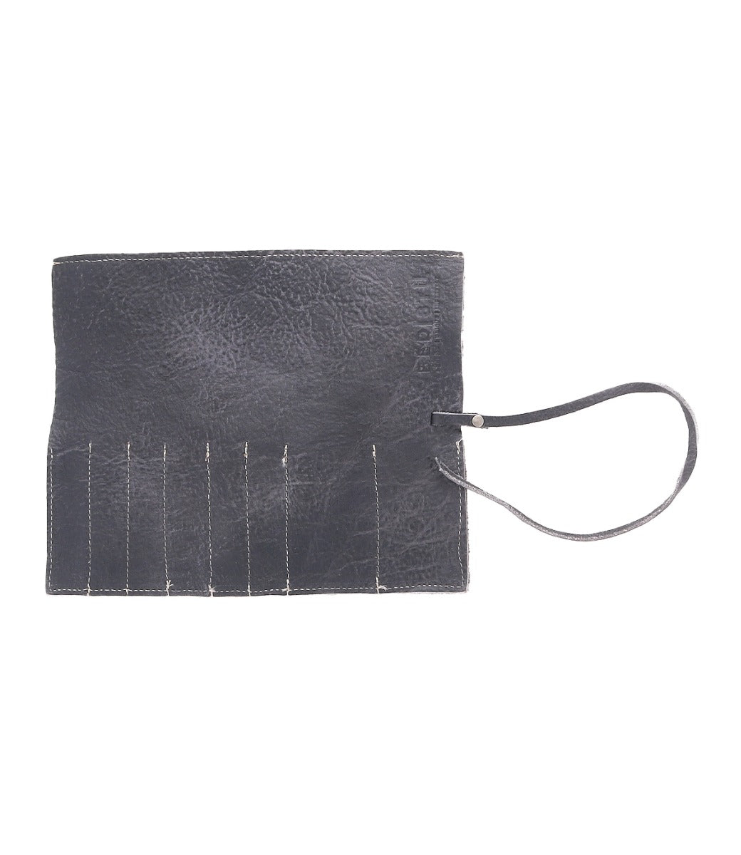 A black leather organizer with a wrist strap, the Prepped Leather Wrap from Bed Stu, featuring multiple stitched slots perfect for holding artist tools.