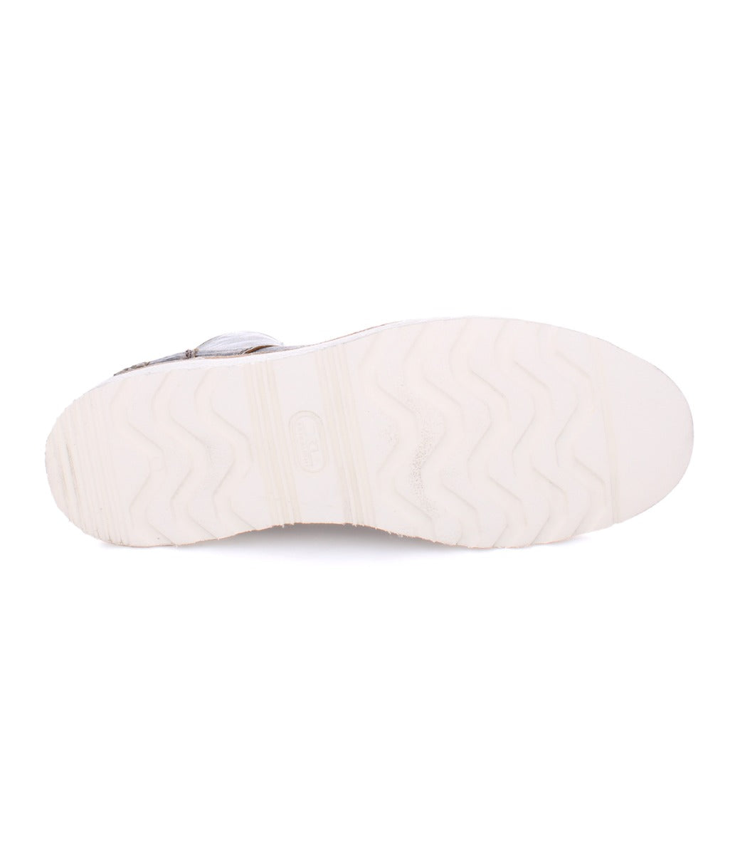 Bottom view of a Protege Light shoe by Bed Stu featuring a white sole with wave-patterned tread and a small logo imprint at the center, complemented by cushioned leather insoles.