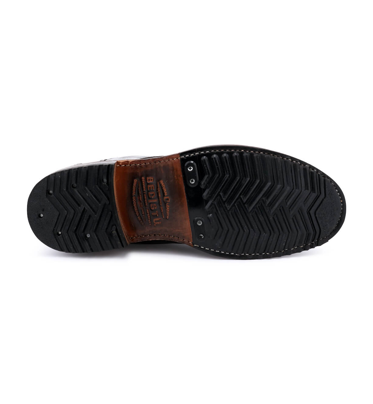 The back view of a Bed Stu men's shoe with black and brown soles.