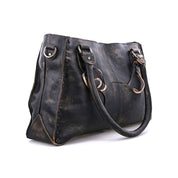 The Rockababy by Bed Stu is a large, black leather handbag with distressed detailing and two handles, perfect as an everyday bag.