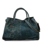 A blue leather Rockaway tote bag on a white background by Bed Stu.