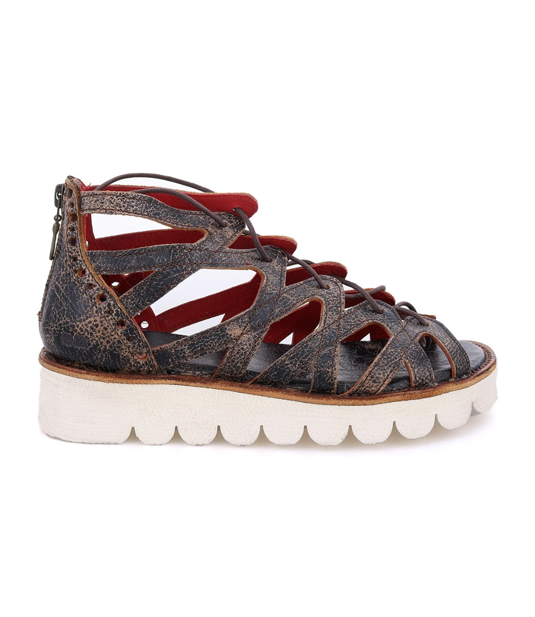 A pair of Bed Stu Shirin II women's brown sandals with a red sole.
