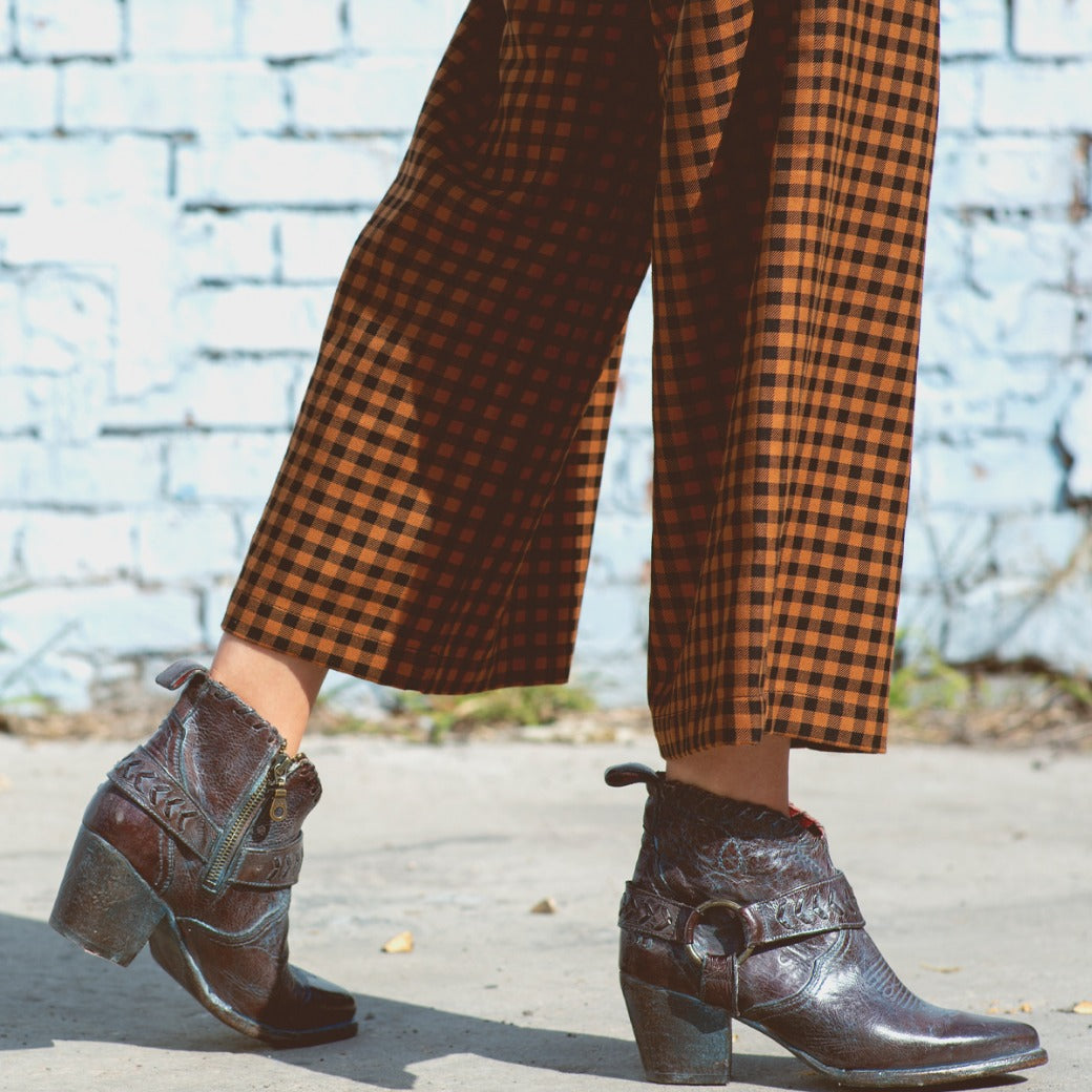 A woman wearing Tania pants and Bed Stu boots.