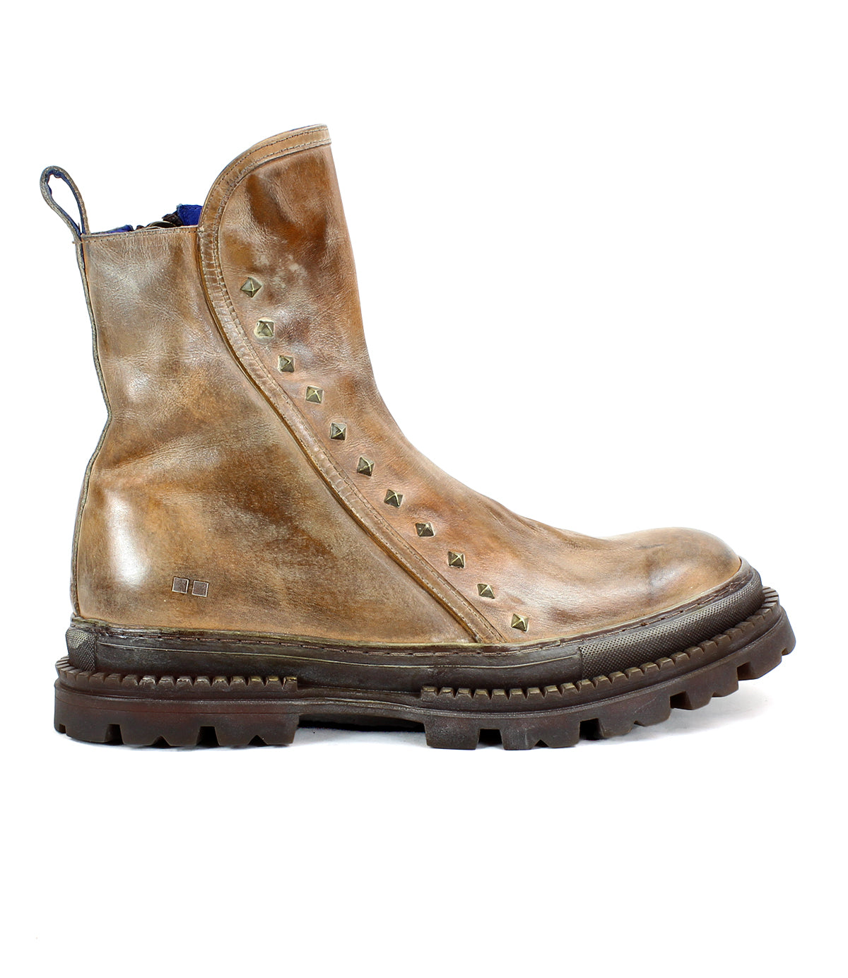 The Bed Stu Tanto is a brown leather men's boot with European flair, featuring a rugged lug outsole and a row of pyramid-shaped metal studs lining the side.