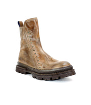 The Bed Stu Tanto is a single brown men’s boot featuring a rugged lug outsole, metallic stud side detailing, and a distressed finish for European-inspired style.