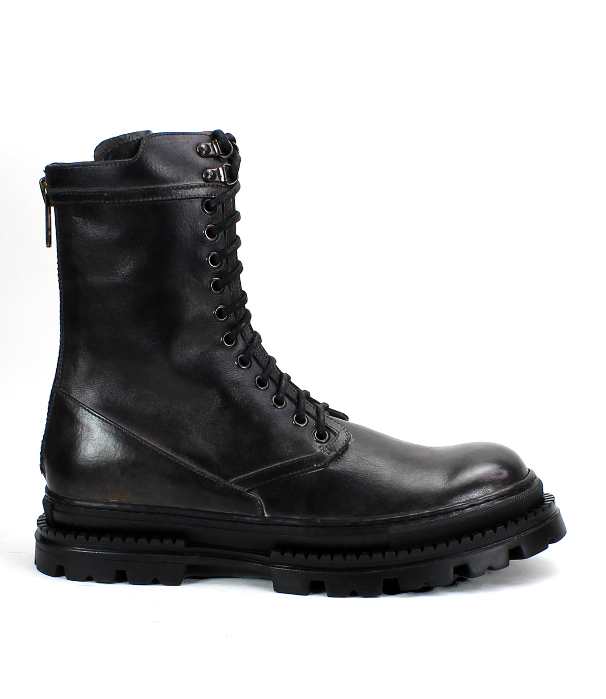 The Bed Stu Tempt is a black lace-up leather combat boot with a thick, rugged rubber sole, blending hiking boot durability and modern style, shown in side profile against a white background.