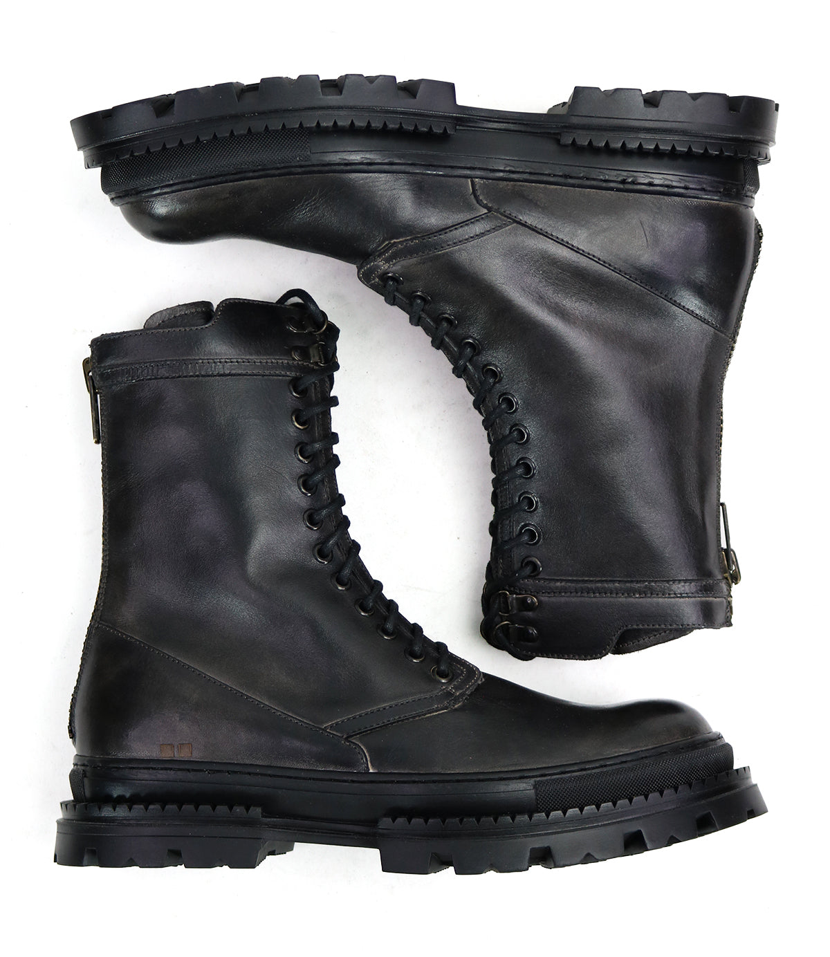 The Bed Stu Tempt is a pair of black leather combat boots with thick, rugged soles, stylishly shown from side and sole views against a white background.