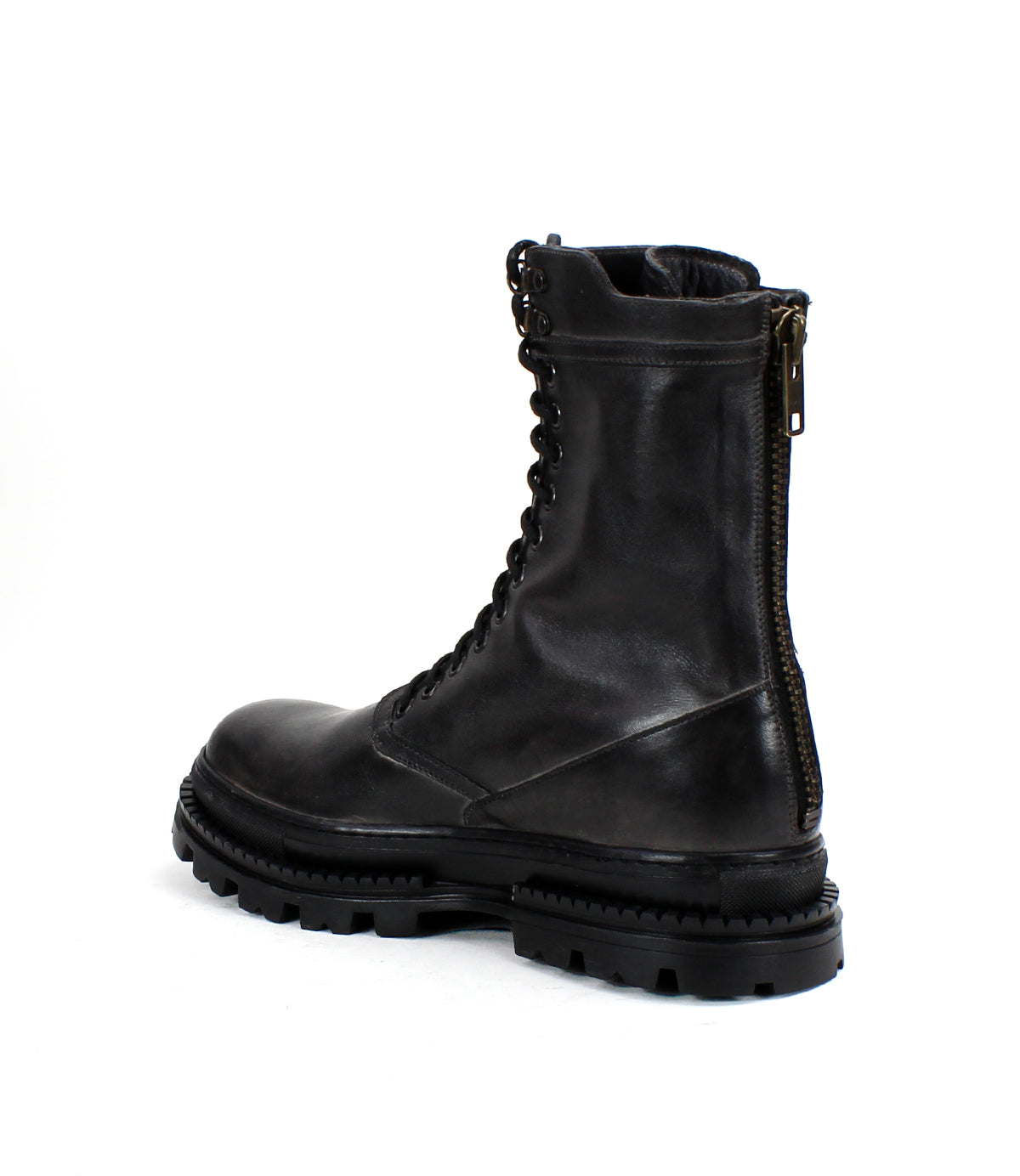 The Bed Stu Tempt is a black leather lace-up combat boot featuring a chunky sole, Chelsea boot influences, and a vertical back zipper—a stylish hybrid enhancement for any wardrobe.