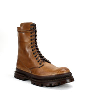 The Tempt hiking boot by Bed Stu in tan leather features a chunky dark brown sole, displayed at an angle on a white background.