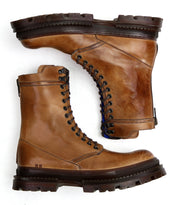 Bed Stu’s Tempt boots feature brown leather and thick rubber soles, arranged side by side on a white background to highlight their stylish blend of rugged durability and modern design.
