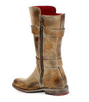 The Bed Stu Turn short leather boot, featuring a side zipper and two adjustable horizontal straps, is showcased against a white background.