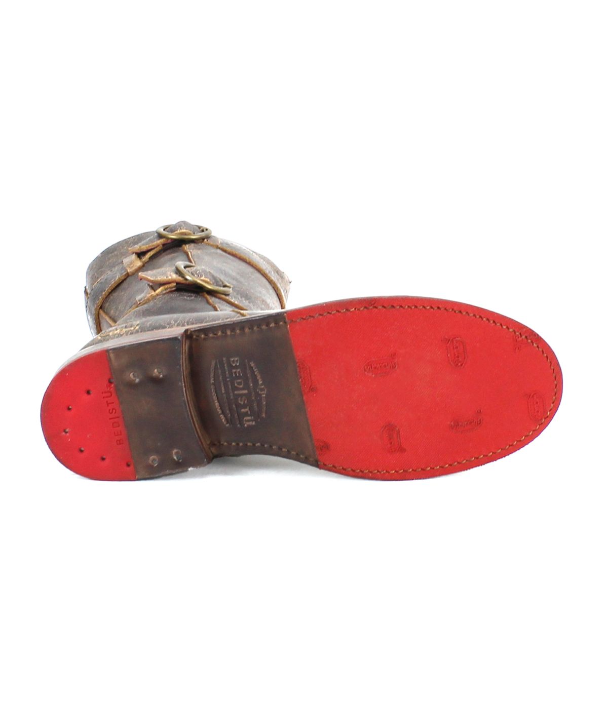 Bottom view of the Bed Stu Turn short brown leather boot with a red sole, featuring Goodyear welted construction, two adjustable straps, and brand name imprints on the sole.