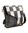 A functional Venice Beach II leather messenger bag displaying a checkered front panel in shades of black, white, and brown, set against a white background by Bed Stu.