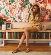A woman's wearing tan Yoli sandals by Bed Stu.