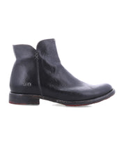 The Bed Stu Yurisa is a black leather ankle boot with visible stitching, a low heel, and red leather lining, shown in a side view on a white background—a stylish everyday choice.