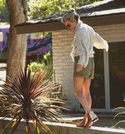 A woman standing on a ledge wearing Yurisa leather boots from the Bed Stu brand.