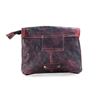 The Ziggy belt bag by Bed Stu, crafted from red and black leather, features a square front pocket and a metal tag at the bottom center, offering hands-free convenience.