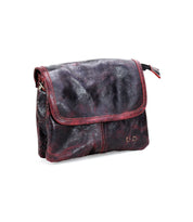The Bed Stu Ziggy is a dark maroon leather crossbody bag featuring a flap closure and a textured surface, perfect for hands-free convenience.