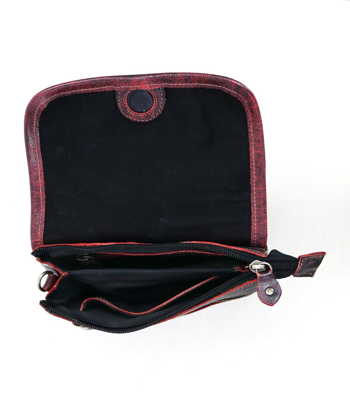Open the Ziggy red leather purse by Bed Stu, featuring a sleek black interior, multiple compartments, and a snap closure, offering hands-free convenience for the on-the-go lifestyle.
