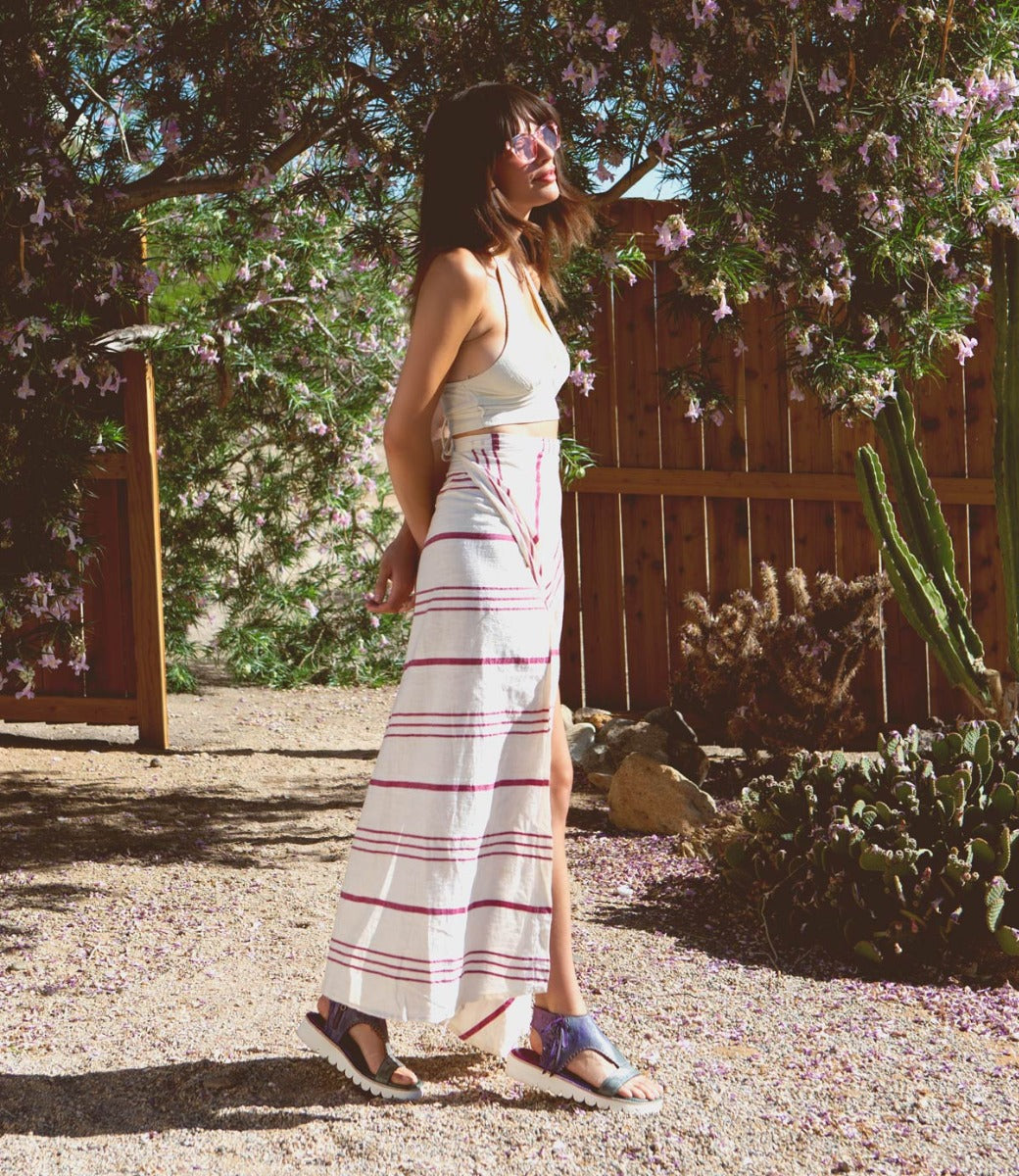 A woman wearing a Bed Stu Zoe II striped maxi skirt and sandals.