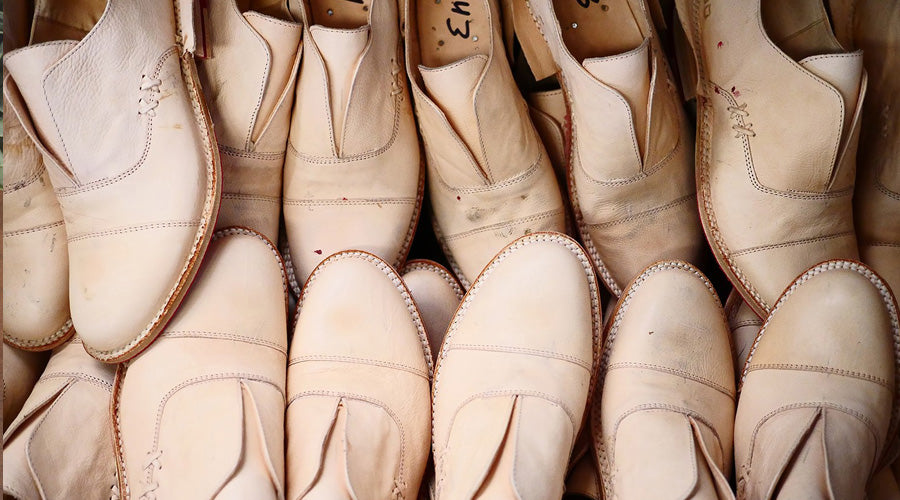 A loaf of bread next to a pair of shoes.