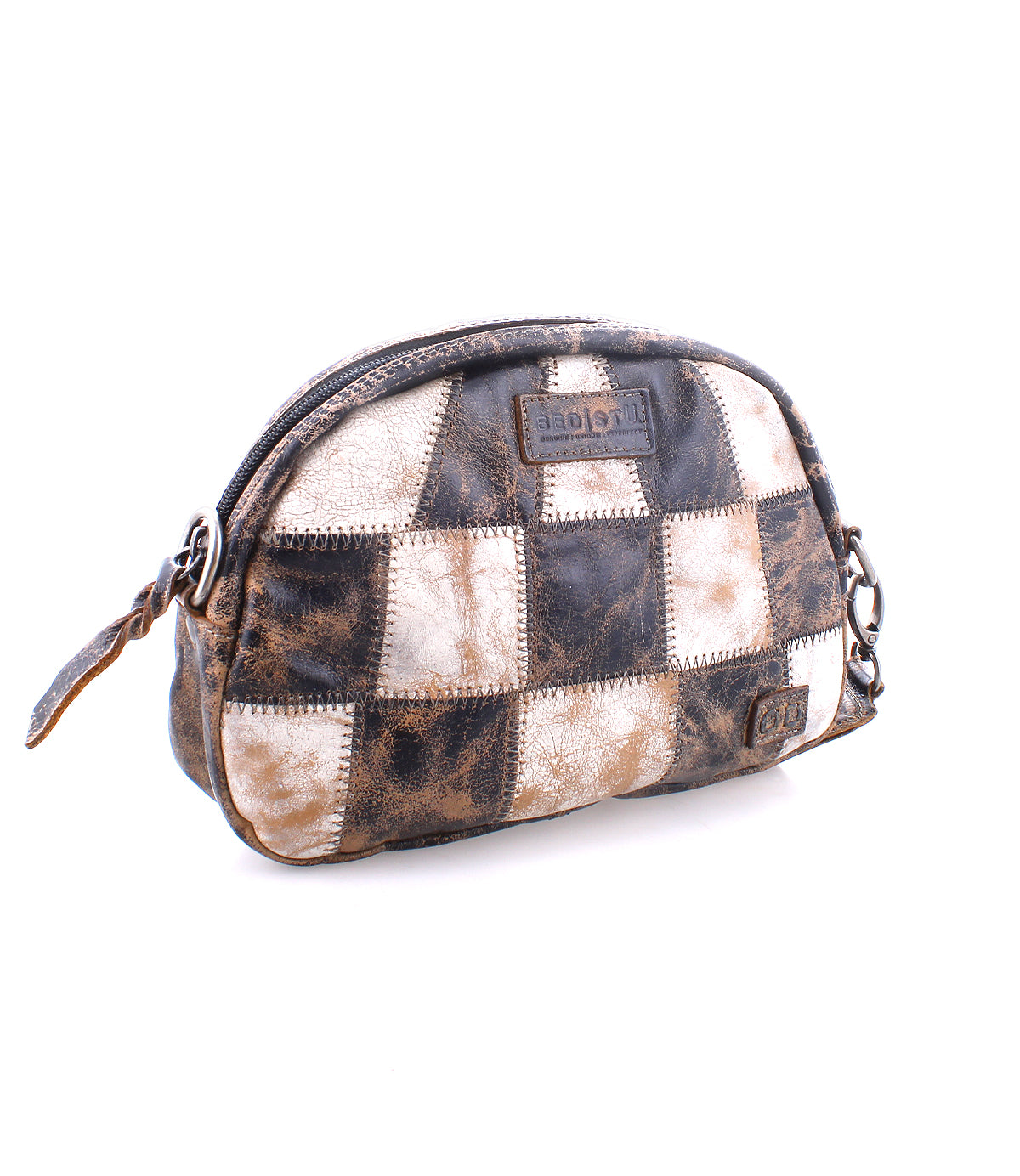 A compact patchwork leather sling bag with a zipper, featuring varying shades of brown and a Bed Stu logo tag.