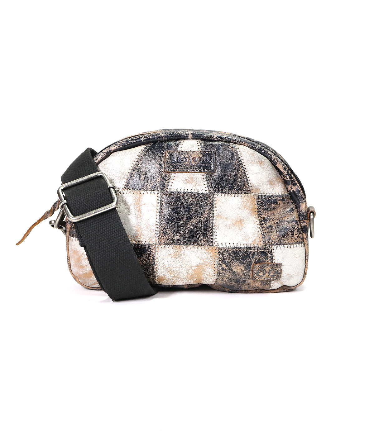 A small, checkered-patterned sling bag with a black strap, featuring various shades of brown and white. The Abundance bag from Bed Stu has visible branding and a zipper closure.