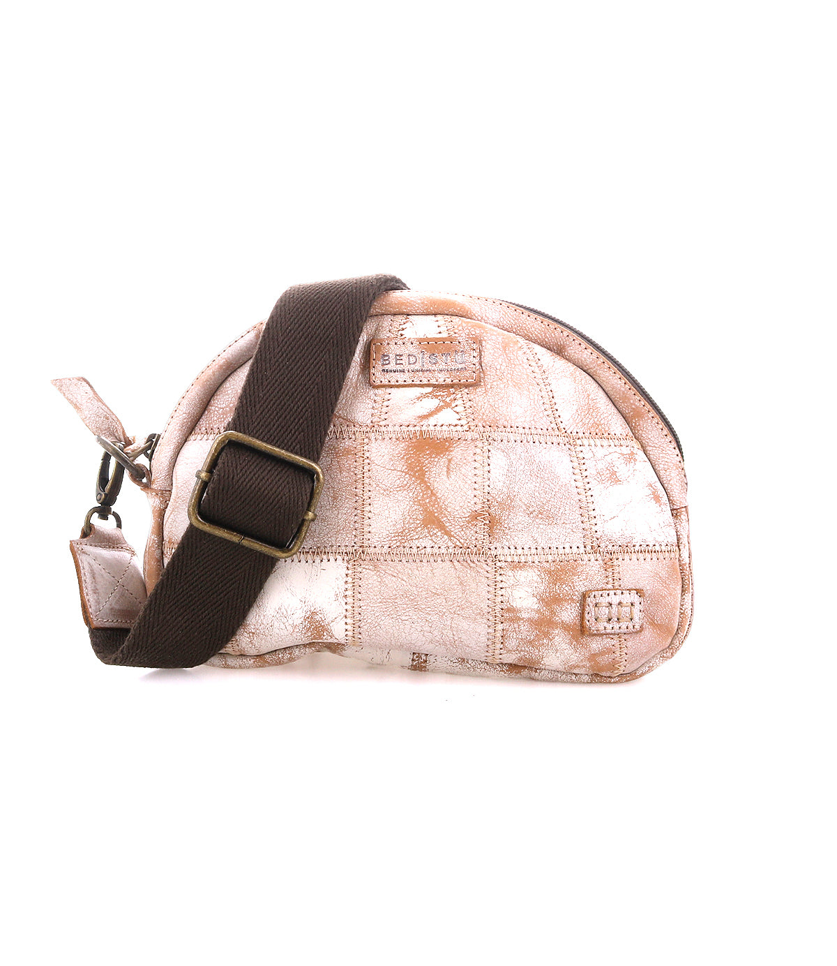The Bed Stu Abundance is a small, dome-shaped sling bag with a light brown and white checkered patchwork design, featuring a wide dark brown adjustable strap and visible zipper for hands-free convenience.